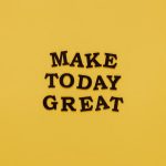 Simple and motivational quote 'Make Today Great' on a minimalist yellow background for inspiration.